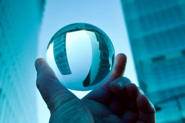 istock Crystal ball against modern buildings 1567665380