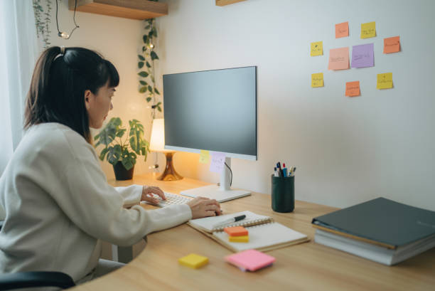 istock young Asian woman writing on notebook while working in home office 1567670126