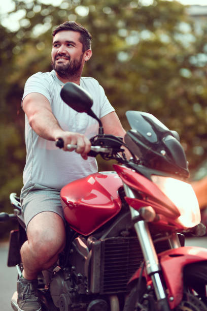 istock Smiling Male Ready To Ride His Motorcycle 1567684861