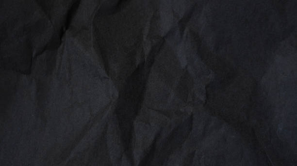 istock Dark abstract textile background texture. Black crumbled paper texture. 1567710891