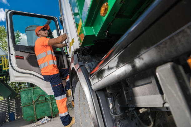 istock Garbage Truck Driver and City Garbage Collecting 1567730379