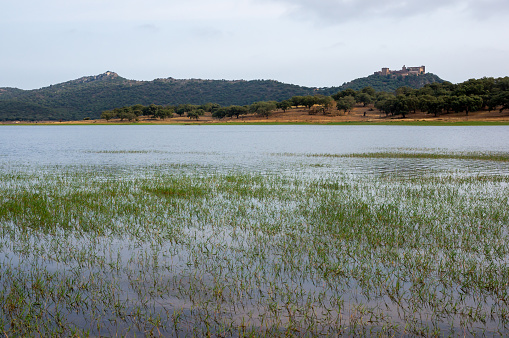 Badajoz, Spain. July 22, 2023. Peña del Águila Reservoir with the castle of Azagala in the background.