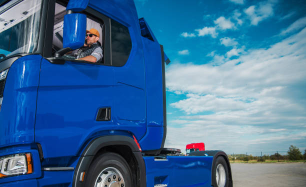 istock Semi Truck Driver Awaiting a Trailer with Shipping Cargo 1567749133