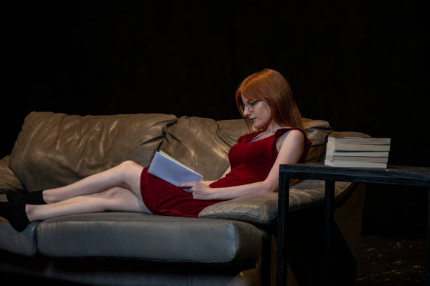 istock Young woman read book at home 1567750685