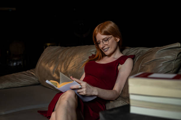istock Young woman read book at home 1567750691