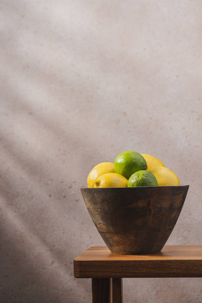 Citrus fruits in bowl on wooden bench in the interior