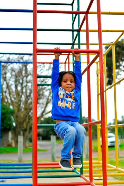 istock beautiful young black African boy with dreadlocks playing in a park . 1567773192