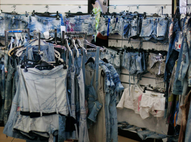 istock Row of hanged blue jeans 1567775761