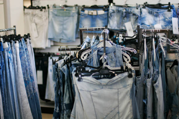 Row of hanged blue jeans in a shop