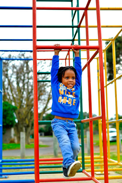 istock beautiful young black African boy with dreadlocks playing in a park . 1567776837