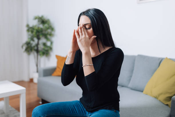istock Woman finds relief from sinus problems while seated on the sofa at home 1567780655