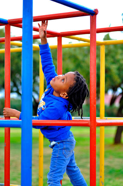 istock beautiful young black African boy with dreadlocks playing in a park . 1567789213