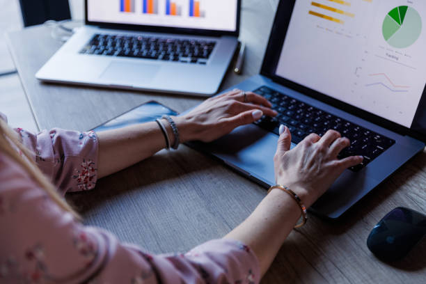 istock Businesswoman sitting at her desk, typing data on laptop when making a graph 1567794843