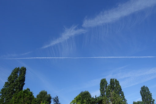 Traces of planes in the sky above a public park in Roissy-en-France