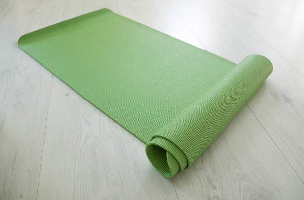 twisted green yoga carpet on a floor