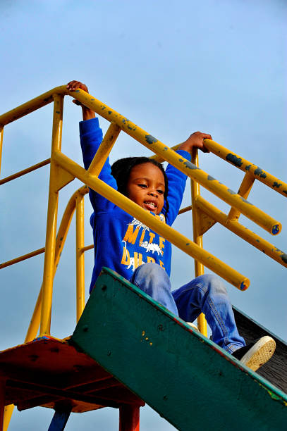 Two kids slide on playground
