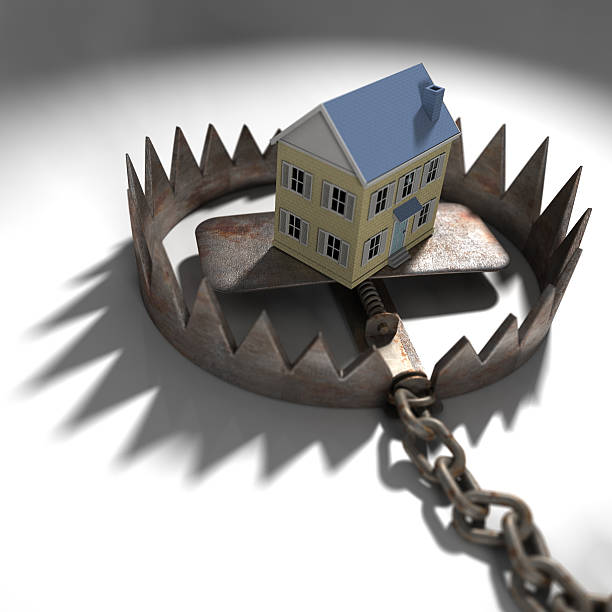 Mock up of a house in a trap, symbolizing mortgage pressure stock photo