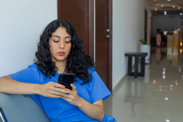 istock Medical personnel taking a break, using the cell phone 1567846551