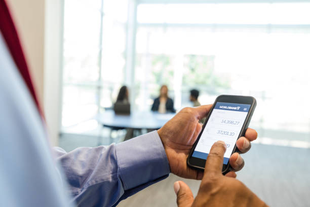 istock Before meeting, man checks online balance using phone 1567851373