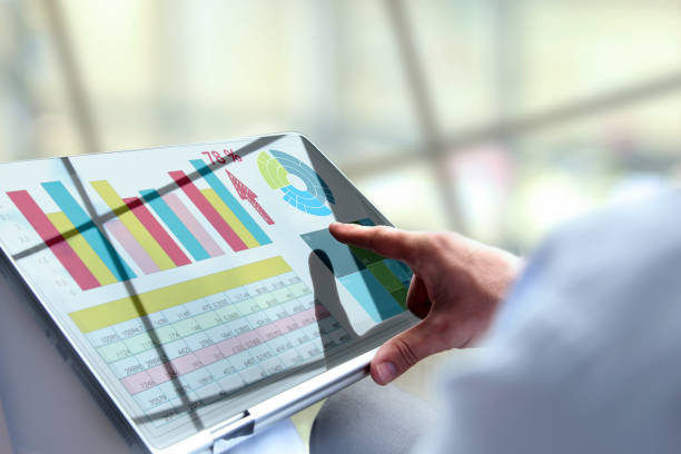 istock Business man working and analyzing financial figures on   a laptop. 1567857133