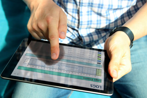 istock Truck driver checking  electronic logbooks on the tablet. 1567858738