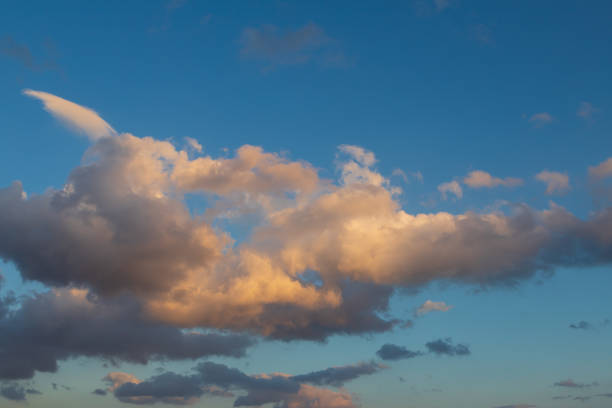 istock Blue sky with white clouds. The sun shines through the clouds. 1567859971