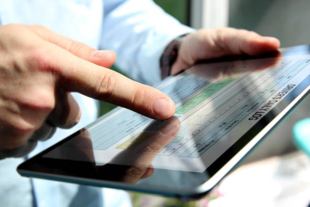 istock Truck driver checking electronic logbooks on a tablet 1567860373