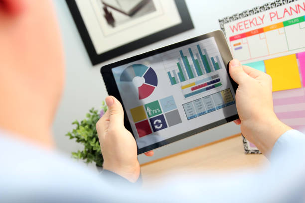 istock Business man working and analyzing financial figures on   a tablet 1567860917