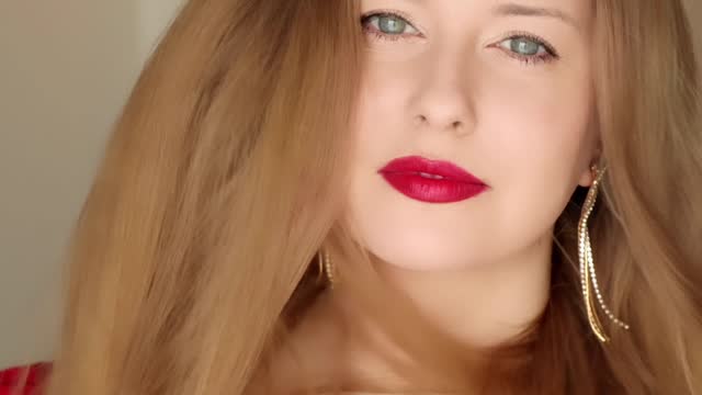 Beautiful happy smiling woman with long hair wearing red lipstick make-up, beauty blogger, influencer video stories reels for social media vlog