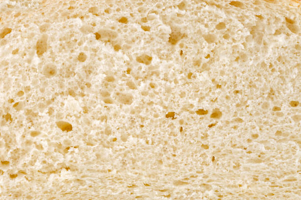 istock Bread, slice, inner part baked dough with pores close-up, background 1567864969