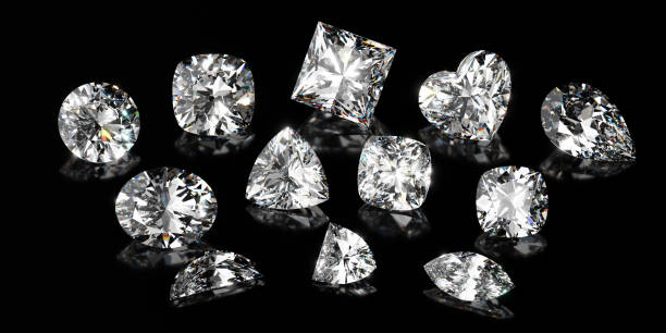 istock Twelve variously shaped brilliant cut diamonds scattered on black glossy background 1567869979