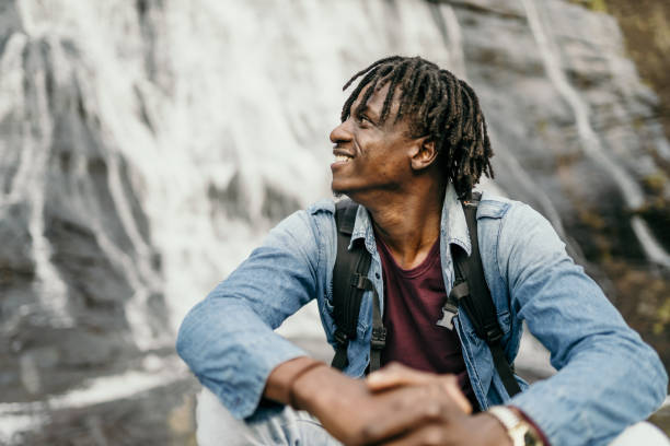 istock Man enjoying an afternoon at the waterfall 1567873696