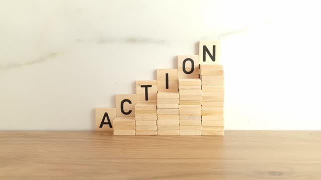 Word action made from wooden blocks