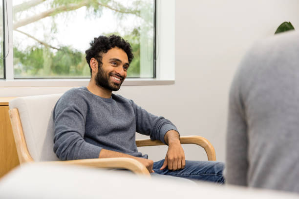 istock Over-the-shoulder view relieved young man in therapy session 1567882085