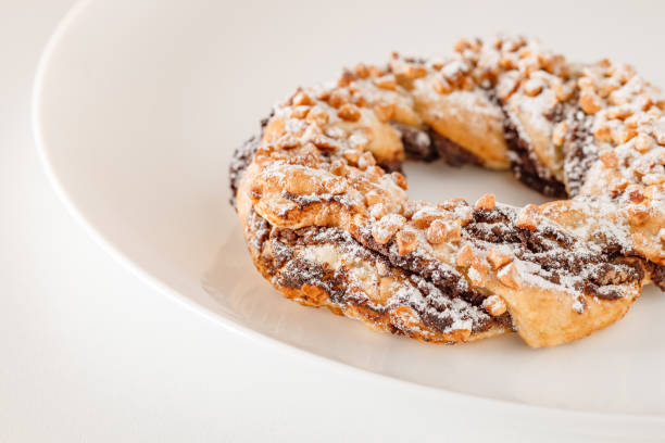 Brezel handcrafted sweet, pastry delicious snack, on white plate board, selective focus