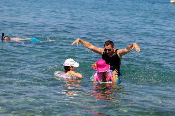 istock Father and Sisters in the Sea 1567913005