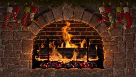 Burning Yule Log in fireplace decorated with christmas stockings.