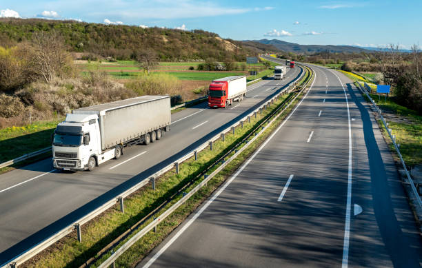 istock Transportation Trucks in lines passing 1567924818