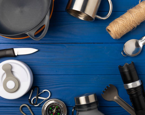 istock Travel equipment set on texture background.EDC set.flat lay.Camping plate,mug,bottle,spoon and compass.Copy space.Top view.Travel concept.Set of tourist equipment 1567928435