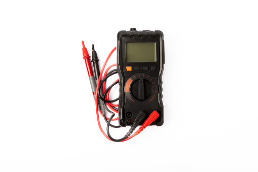 Digital multimeter with probes and display isolated on white background. Electrical tool.Black digital multimeter with probes on a white background, the multimeter is an electronic measuring instrumen