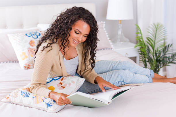 istock Young female student relaxing on bed 1567942358