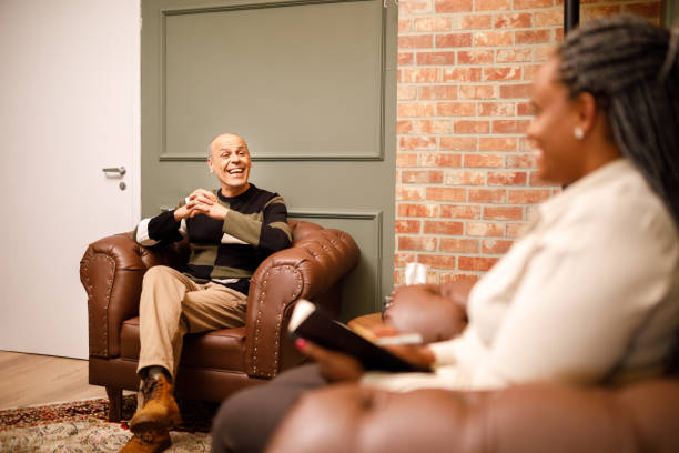 istock Happy man bonding with his therapist during session 1567949493