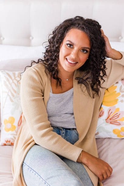 istock Woman sitting casually at home on bed 1567951604