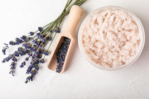 Natural lavender scrub on a white texture background.Body scrub. Body care. Sugar peeling scrub with argan oil and Himalayan salt. spa set