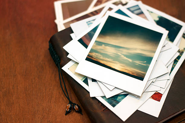 polaroid pictures of sunset on leather journal - tafel fotos stockfoto's en -beelden