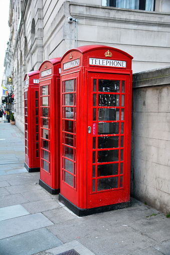 Old red phone booths on the street.