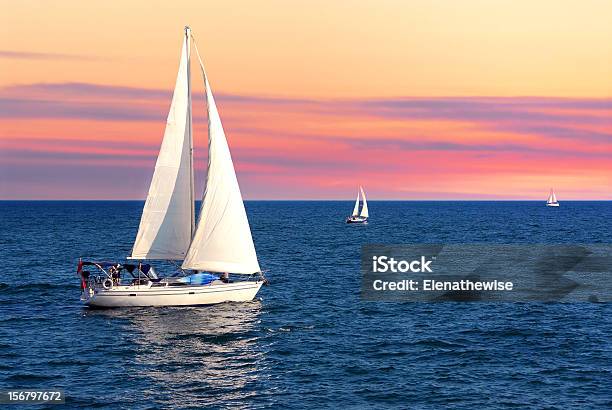 Sailboats At Sunset Stock Photo - Download Image Now - Sailboat, Sailing, Sail