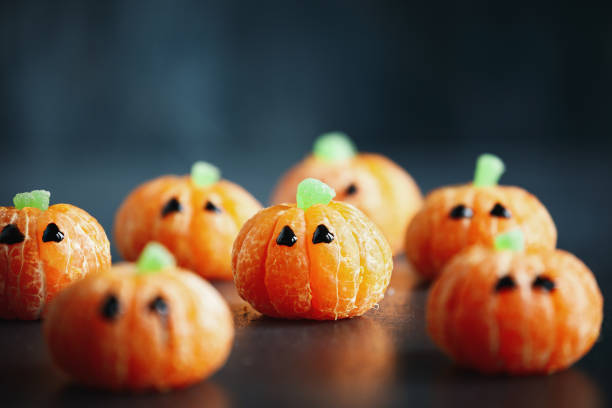 istock Halloween cute pumpkin orange fruit with chocolate eyes 1567980866