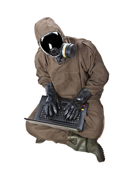 istock Man in Hazard Suit with laptop 156799033