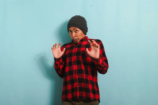 istock Annoyed young Asian man repulsing something with disgusted expression, isolated on blue background 1567997345